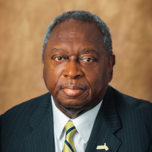 A Man Wearing A Suit And Tie